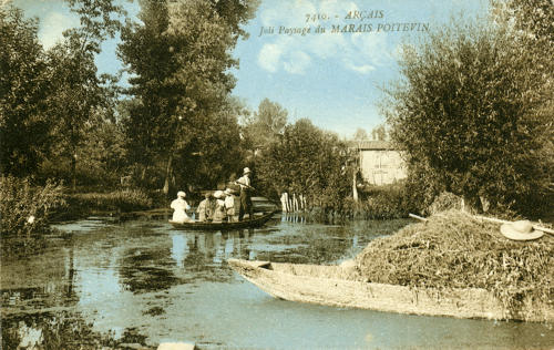 Des touristes se promènent en barque dans le marais d'Arçais. Marais poitevin